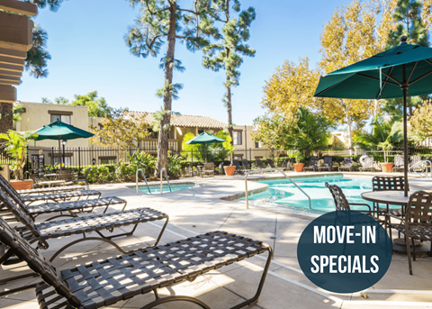 a swimming pool with lounge chairs and umbrellas at the resort